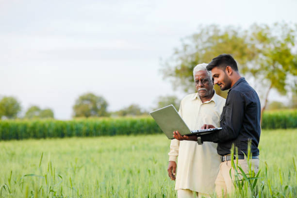 istock young indian agronomist with farmer at field 1316735482