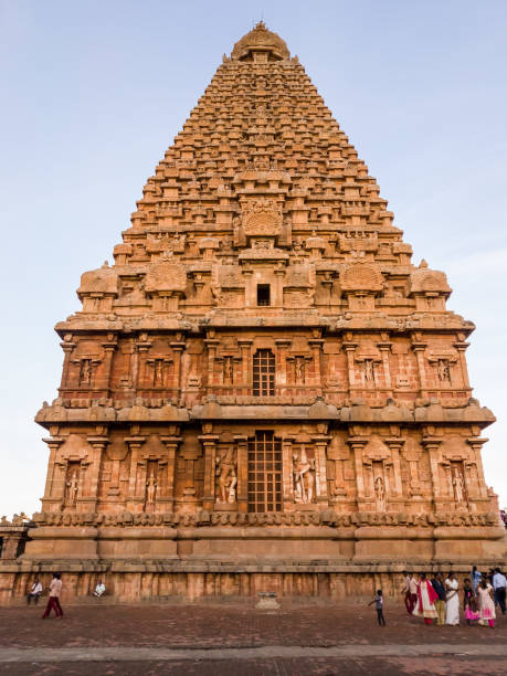 The main tower of an ancient Hindu temple Thanjavur, Tamil Nadu, India - January 2017: The main tower of the ancient Hindu temple of Brihadeeshwarar aka Big Temple with crowds of tourists in the town of Thanjavur. dravidian culture photos stock pictures, royalty-free photos & images