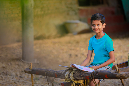 Cute indian child studying at home