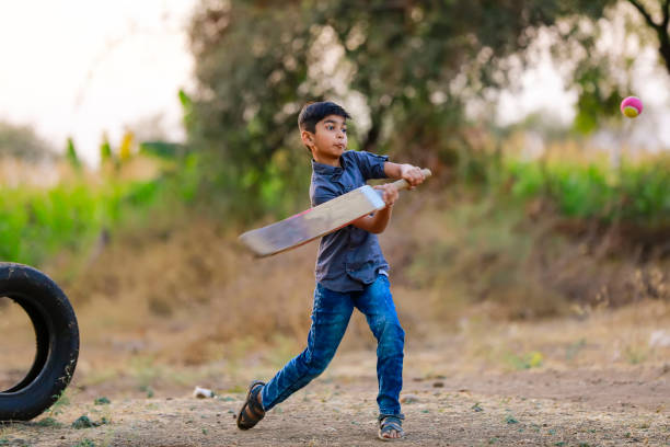 istock Rural Indian Child Playing Cricket 1316738114
