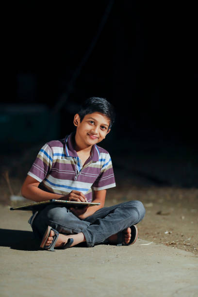 istock Poor child doing his homework at home 1316738175