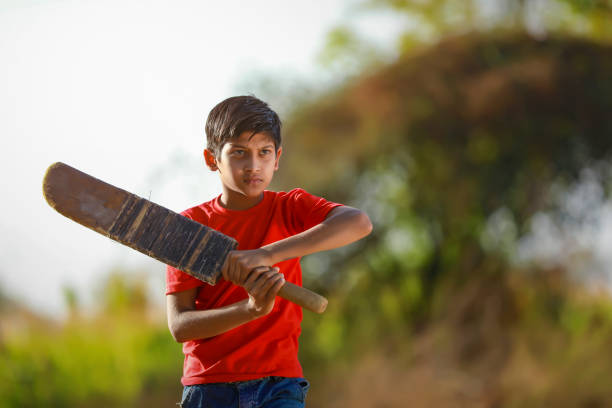istock Rural Indian Child Playing Cricket 1316738179
