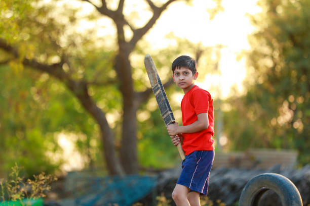 istock Rural Indian Child Playing Cricket 1316738186
