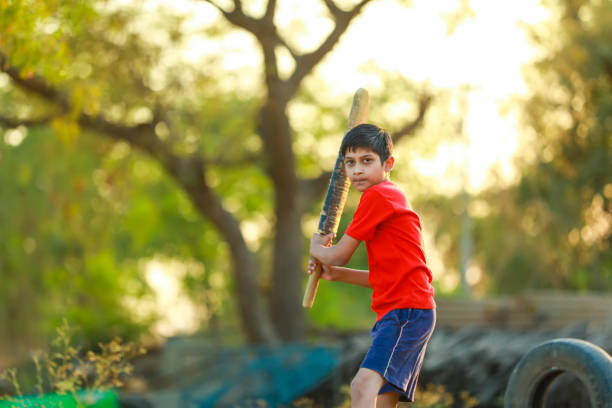 istock Rural Indian Child Playing Cricket 1316738222