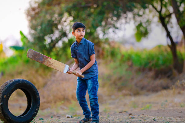 istock Rural Indian Child Playing Cricket 1316738231