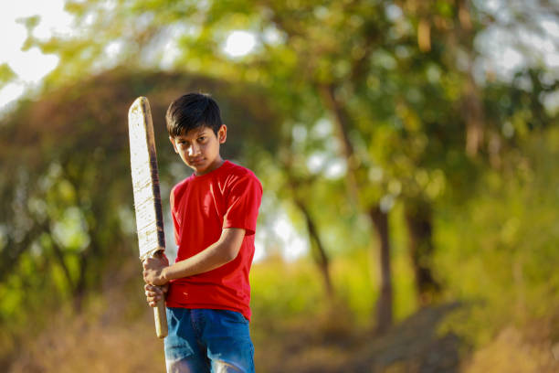 istock Rural Indian Child Playing Cricket 1316738331