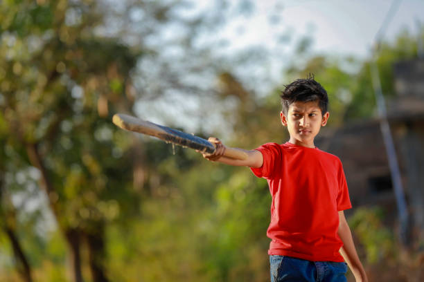 istock Rural Indian Child Playing Cricket 1316738355