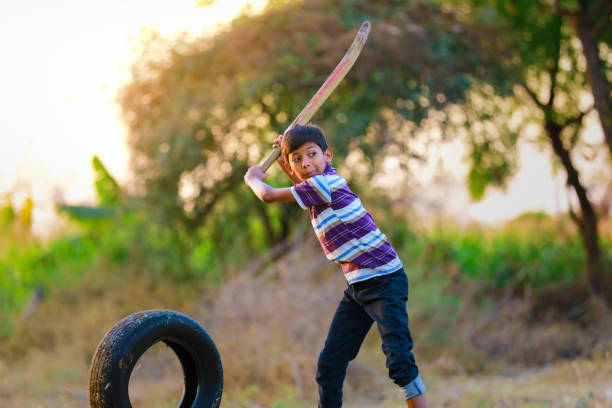 istock Rural Indian Child Playing Cricket 1316738556