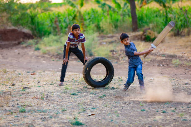 Rural Indian Child Playing Cricket