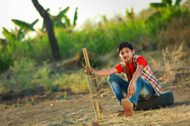 istock Rural Indian Child Playing Cricket 1316738636