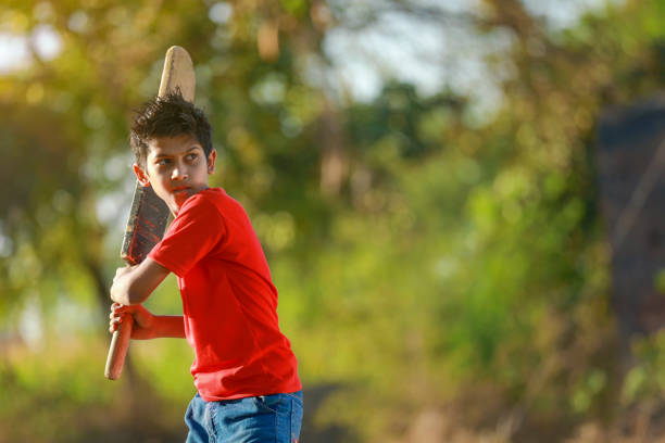 istock Rural Indian Child Playing Cricket 1316738644