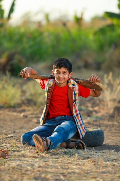 istock Rural Indian Child Playing Cricket 1316738658