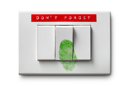 Energy saving. Light switch with green fingerprint on it isolated on white background.