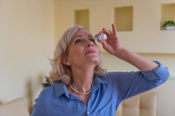 istock An Elderly Woman with Eye Problems is Applying an Eye Drops. 1316739780