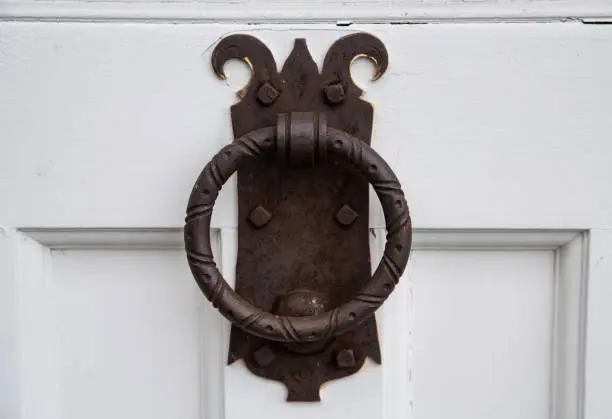 Antique door knocker on old building