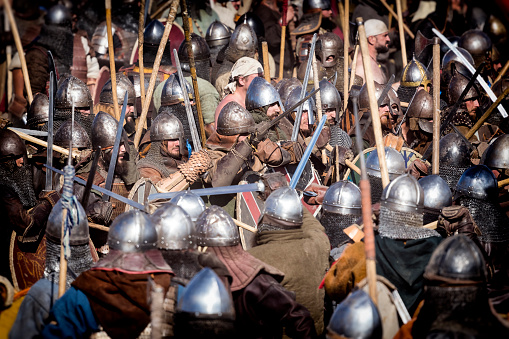 Wolin, Poland - August 05, 2018:Reenactors dressed in Viking and Slav armor uniforms fighting in the battlefield during annual the Wolin Viking Festival, Poland. Wolin Viking Festival is an important meeting point for Viking and Slav reenactors of Europe