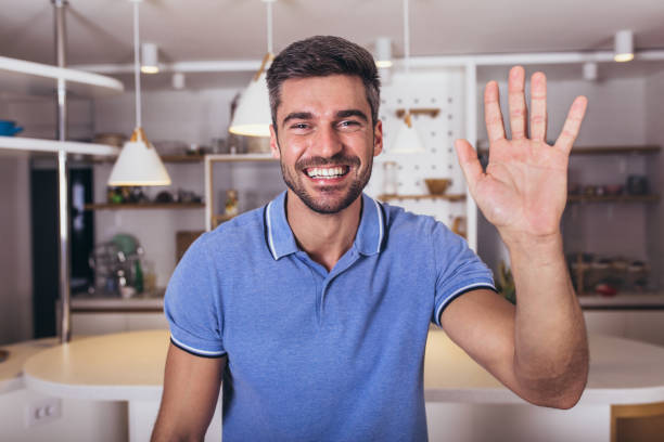 istock Positive smiling young man indoors at home looking camera. 1316740991