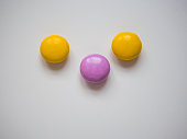 Top view of yellow and purple chocolate candy with copy space.