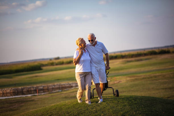 istock Senior golfers talking and walking on golf course. 1316742611