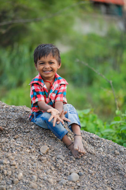 istock indian poor child playing at home 1316744096