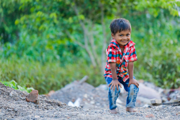 istock indian poor child playing at home 1316744122
