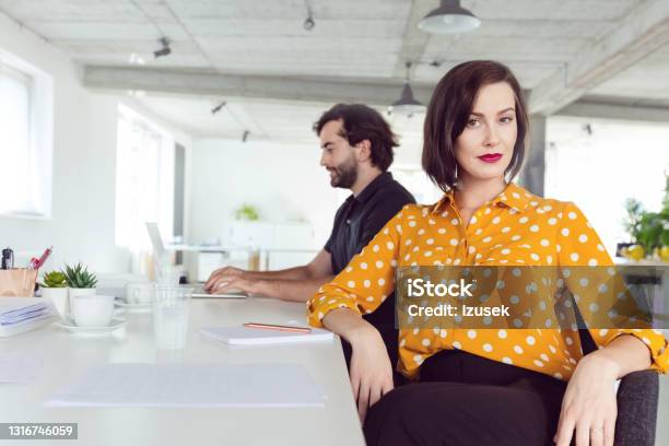 Portrait Of Woman In The Office Stock Photo - Download Image Now - Yellow, Contemplation, Copywriter