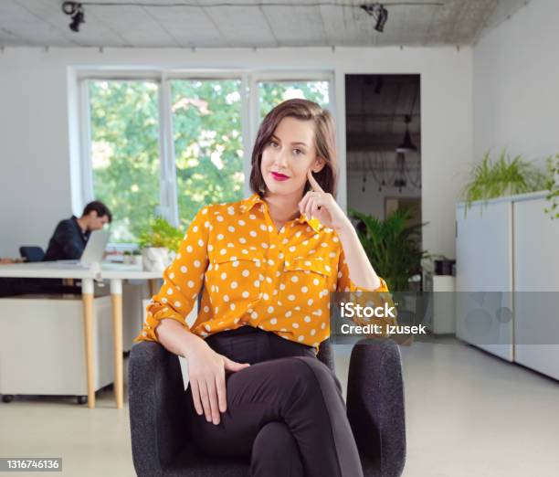 Portrait Of Woman In The Office Stock Photo - Download Image Now - Yellow, Contemplation, Office