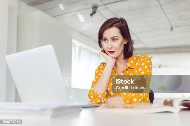 Woman Working In The Office Stock Photo - Download Image Now - Businesswoman, Contemplation, Hand On Chin