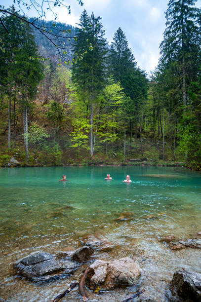 istock Small group of people standing in a cold river 1316748288