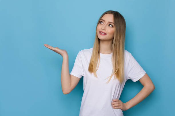 istock Young Woman Is Holding Hand Raised And Looking Aside 1316750844