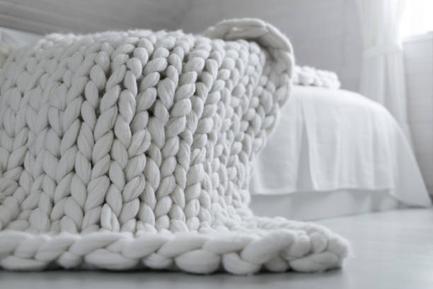 istock White nordic bedroom interior with knit plaid 1316751375