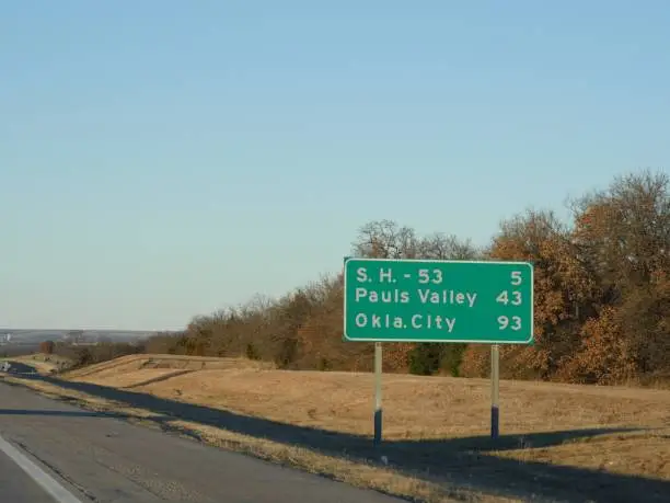 Roadside sign along Interstate Highway 35 with distance to Pauls Valley and Oklahoma City.