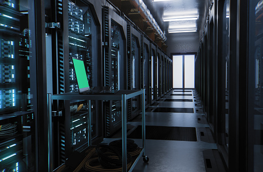 A large hallway with supercomputers inside a server room data center. Technology used for cloud computing and network security. With chroma key green screen.