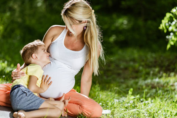 istock Pregnant mother and son having fun 1316753879