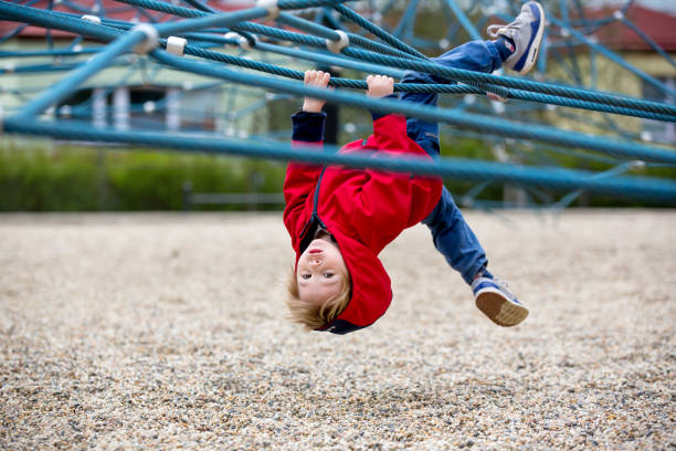 Cute toddler boy, playing on the playground springtime