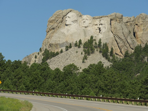 View from the road of the stone monuments of four US presidents at Mount Rushmore National Memorial in South Dakota.