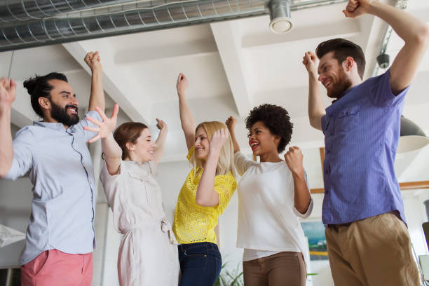 istock happy creative team celebrating victory in office 1316755761