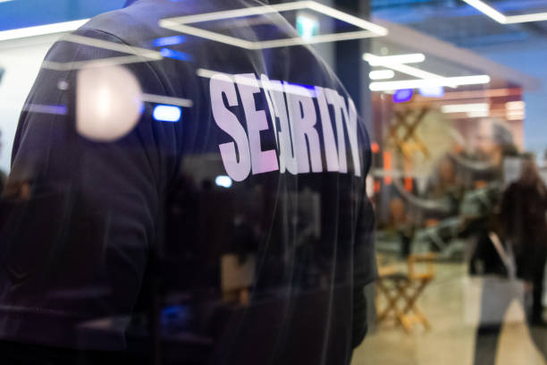 istock Security guard standing inside a commercial building nearby the window reflecting light 1316755783