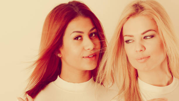 Women and friends take self-portraits for selfies, travel, or holidays, seen from the point of view of the camera with their hands extended. Posting online or on social media. Close up, outside, two people, selective focus.