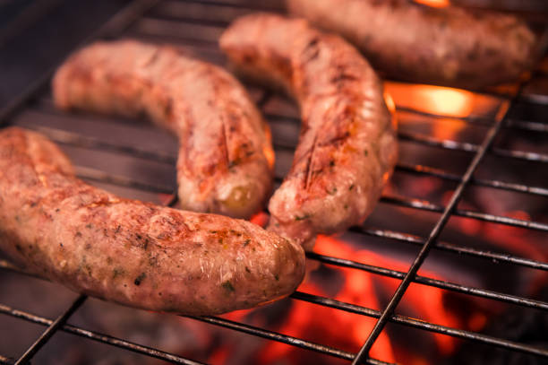 istock Bratwurst  on the grill with flames 1316757275