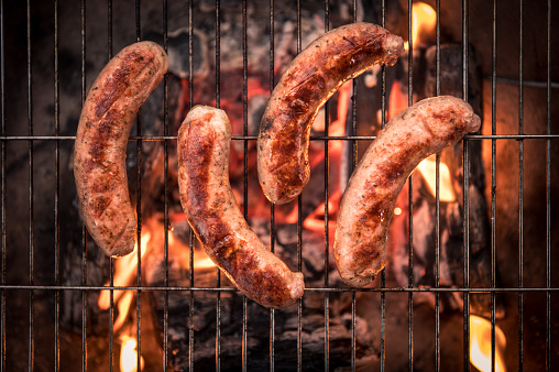 Bratwurst  on the grill with flames