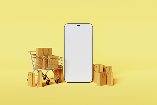 mockup of modern mobile phone with shopping cart and cardboard bags around it with yellow background. online store. 3d render