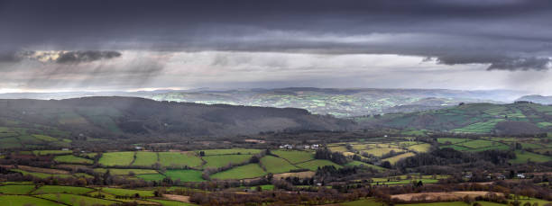 Rain clouds over Carmarthenshire Rain clouds over the hills and fields of Carmarthenshire in South Wales UK storm cloud sky dramatic sky cloud stock pictures, royalty-free photos & images