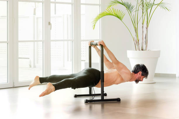 istock Man performing a back lever calisthenics pose on a bar 1316758705