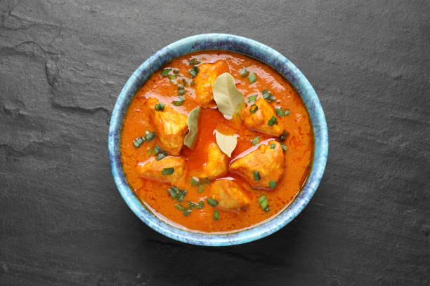 istock Bowl of delicious chicken curry on black table, top view 1316759120