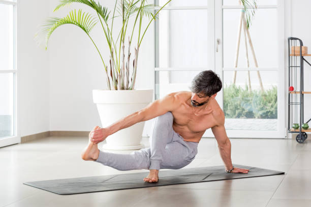 istock Athletic sporty man doing a yoga balance pose 1316761690
