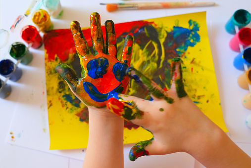 Child painting by finger hand . Ideas for drawing with finger paints. Children development . The concept of a happy childhood and children's day.