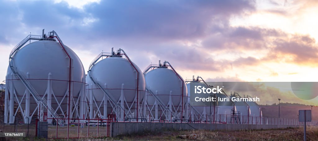 Gas storage tanks at sunset. Concepts series. Natural Gas Stock Photo