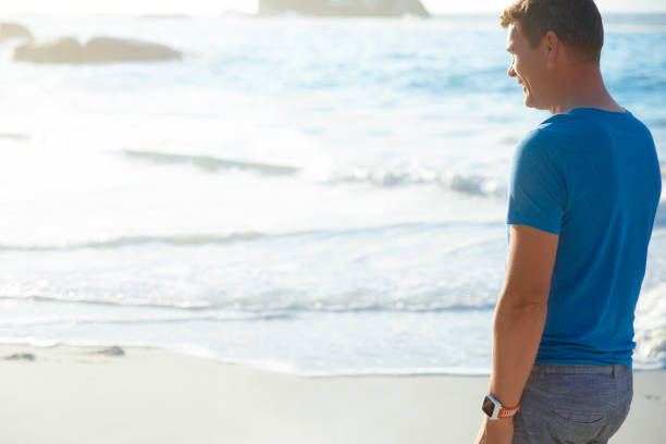 istock Man walking on the beach 1316767787