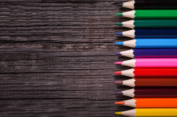istock Colour pencils on wooden background 1316768724